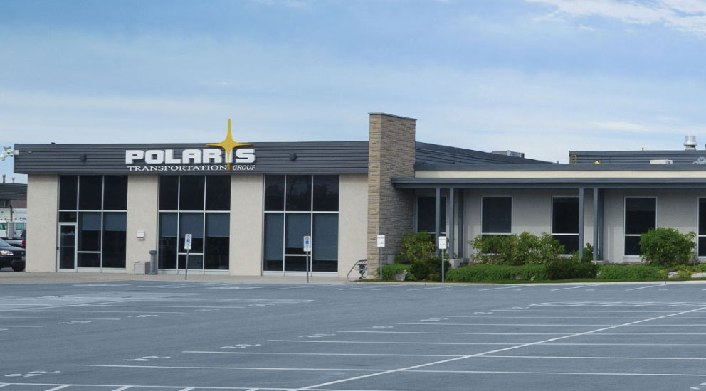 Exterior of Polaris headquarters with parking lot 